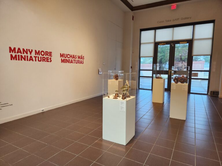 Wide angle shot of the education gallery with exhibition title and multiple pedestals present